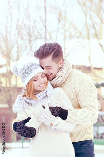 Young couple embracing outd...
