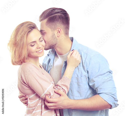 Young man embracing and kis...