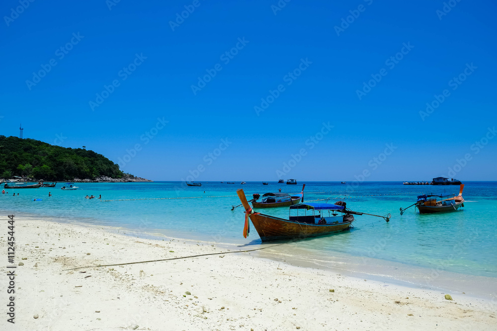 fishing boat against clear sea and blue sky