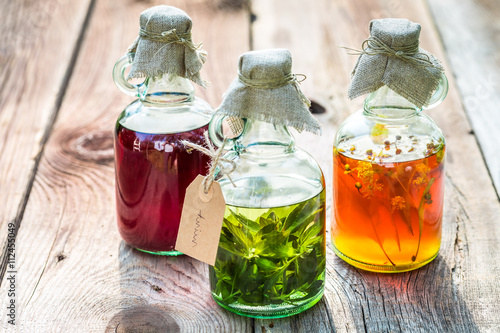 Bottles with honey, linden, mint and alcohol as natural medicine