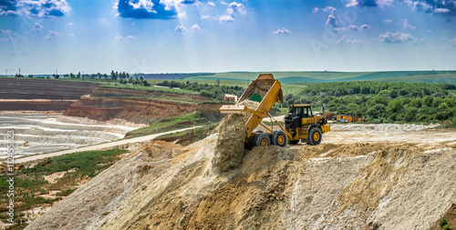 Valokuva Kaolin quarry with white gypsum material and truck