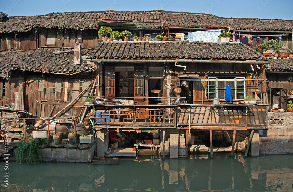 Shanghai, Wuzhen historic scenic town typical old houses reflection in a canal. Shanghai, Wuzhen historic scenic town typical old houses reflection in a canal.