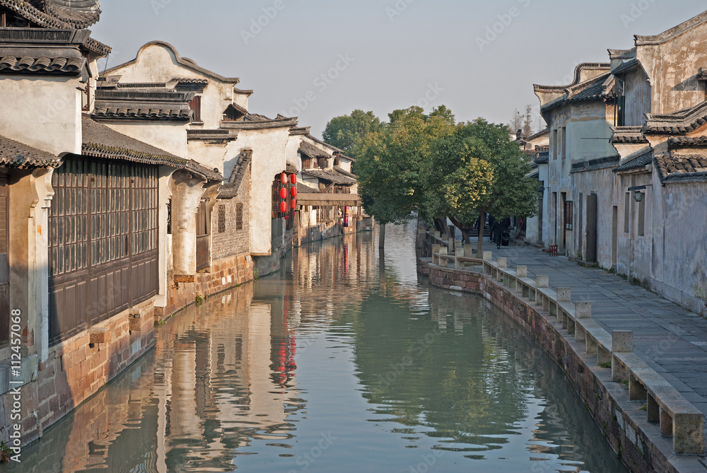 Shanghai, Wuzhen historic scenic town typical old houses reflection in a canal.  