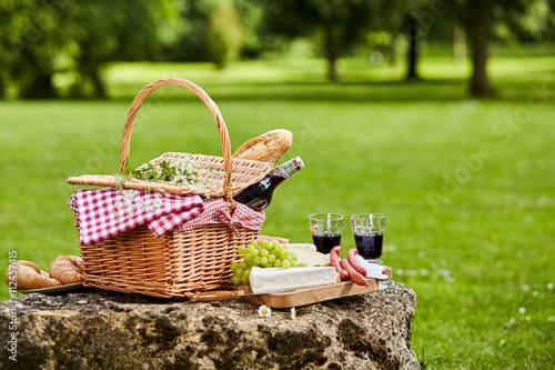 Elegant picnic with red wine, cheese and sausages