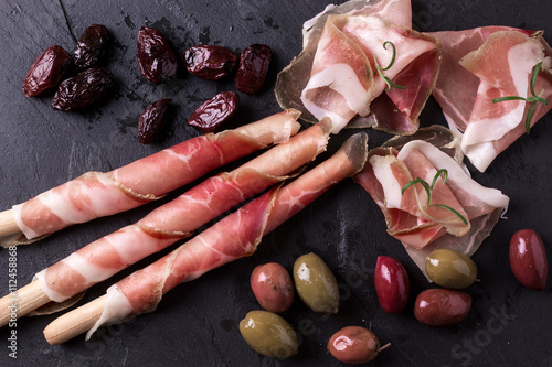 Curled Slices of Delicious Prosciutto with spice Italian cuisine
