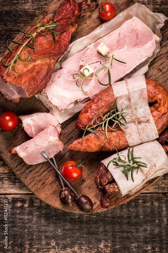 Antipasto catering platter with salami and meat on a wooden background photo