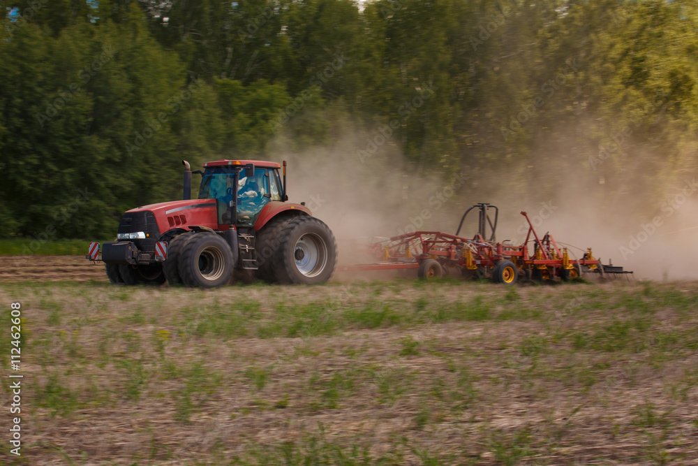 Naklejka premium Working Harvesting Combine in the Field of Wheat