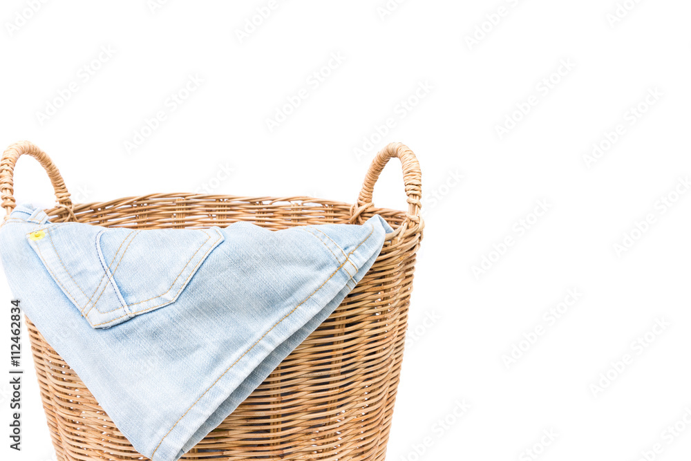 Closeup jeans on wicker baskets on white background