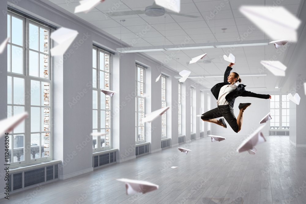 Fototapeta premium Dancing businesswoman in office