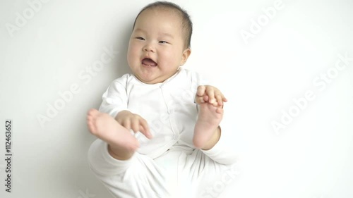 cute asian baby dressed in white