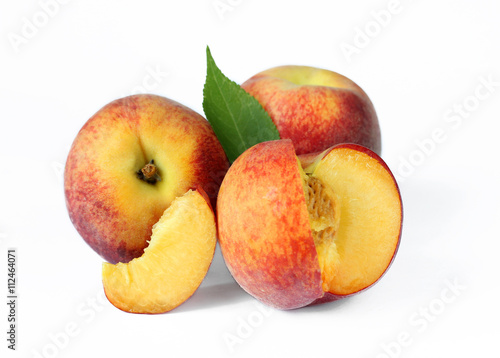 Whole and sliced peaches isolated