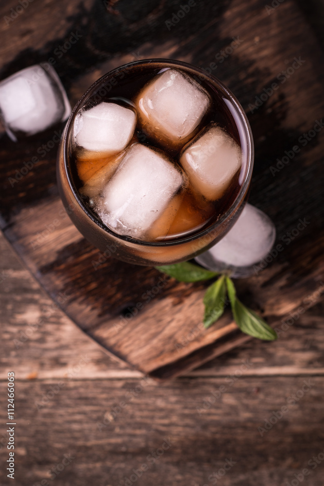 cold drink with ice on wooden vintage table