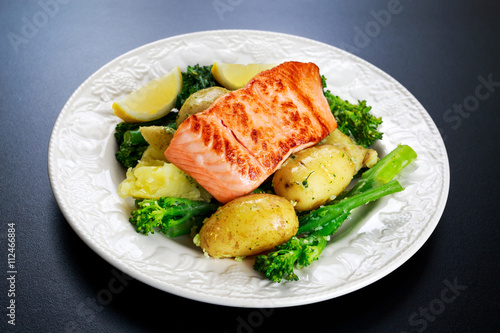 Pan fried Salmon Served with potatoes and tenderstem broccoli.