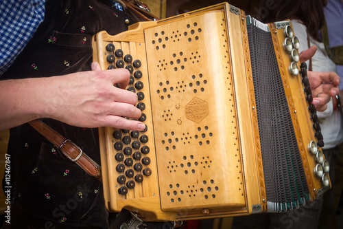 Traditional Bavarian accordion player playing folk music in Austria