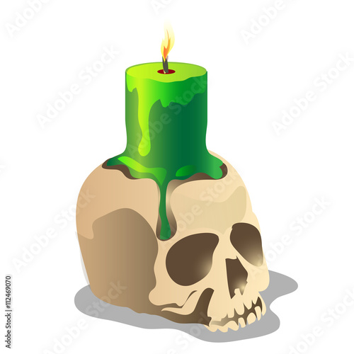 Human skull and a green burning candle on it