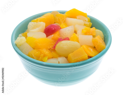 Bowl full of fruit cocktail isolated on a white background.
