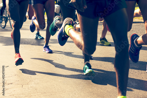 closeup of runners legs in a marathon