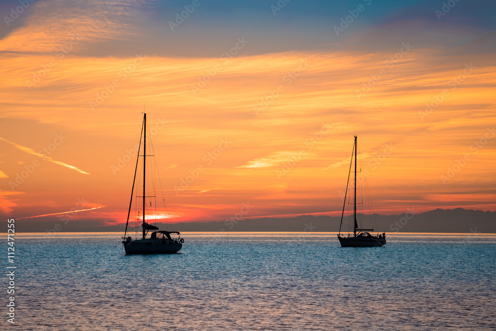 Yachts in the sea at sunset time