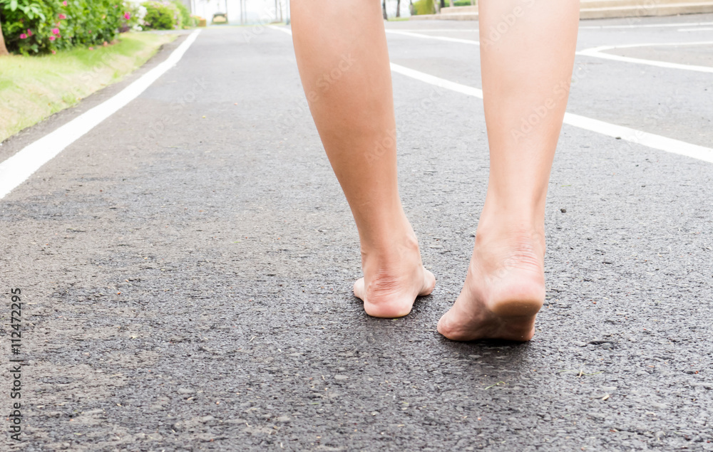 Women legs walking on the road Women legs walking on the road