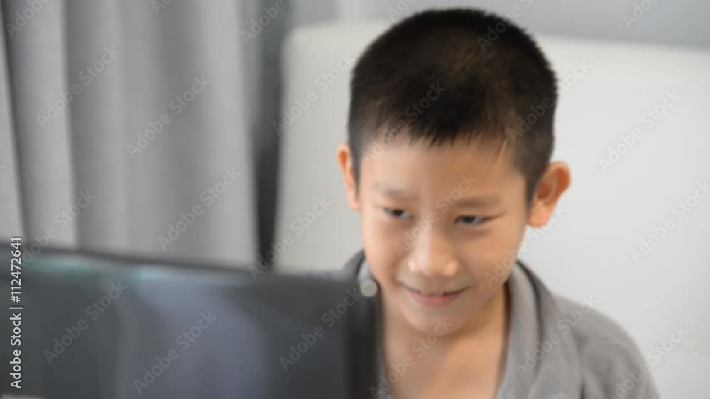 Stress Asian boy during playing computer game at home. Stress Asian boy during playing computer game at home.