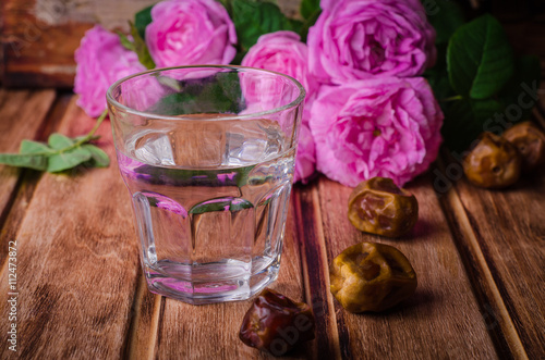A glass of drinking water and date fruits - a food that is consumed before breaking fast during holy month of Ramadan. Selective focus