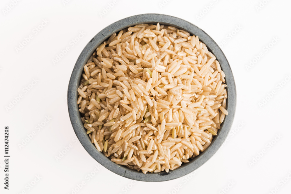 brown rice in a bowl isolated on white background brown rice in a bowl isolated on white background