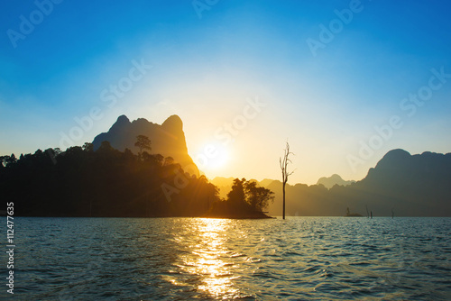 Sunset behind mountain and blue sky at Khaosok Lake