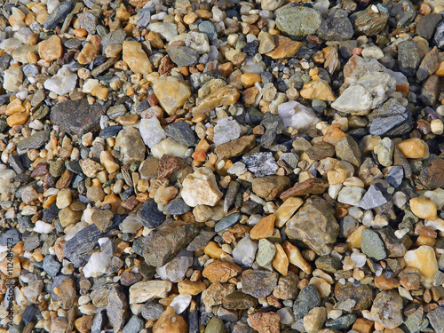 Colored stones background on the bottom of the canyon .