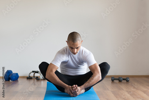 Man in sports clothes stretching after a workout.