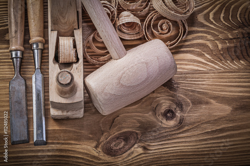 Chisels shaving plane shavings wooden mallet on wood board const