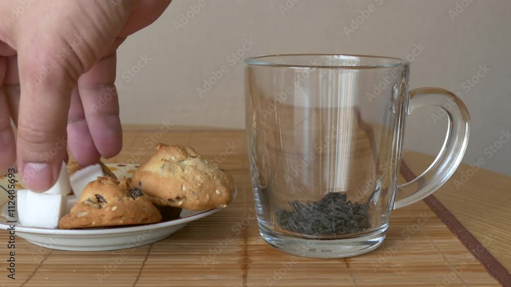 Pour black tea in a glass mug. Pouring healthy black tea. Brew tea in a beautiful glass mug. Tea being poured into glass mug. Pour black tea in a glass mug. Pouring healthy black tea. Brew tea in a beautiful glass mug. Tea being poured into glass mug.