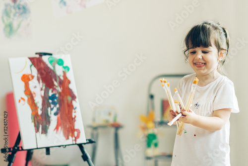 Cut girl painting in at her home