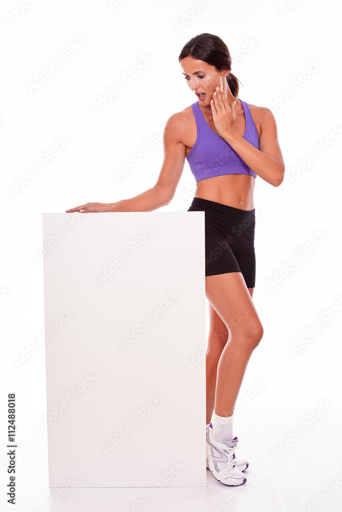 Healthy surprised brunette holding blank placard Healthy surprised brunette holding blank placard