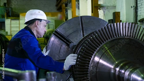 lathe operator in a factory for the production repair rotor for compressor turbine