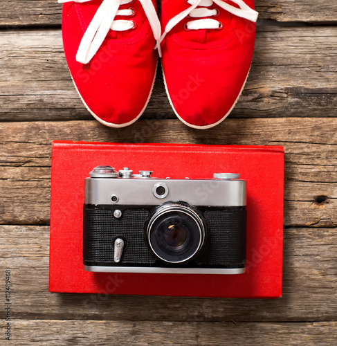 Tourism concept - set of stuff with camera and other travel things on wooden table background