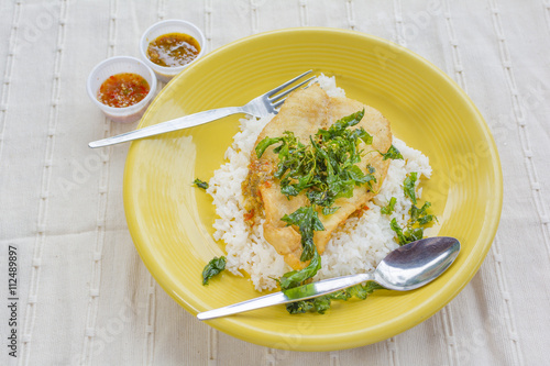 Deep Fried Dolly Fish Steak with sauce Stir basil crispy herb hot and spicy delicious Thai food style