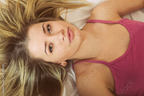 Beautiful young adult attractive blonde woman in pajamas