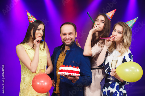 Happy birthday! Group of smiling friends gathered together with