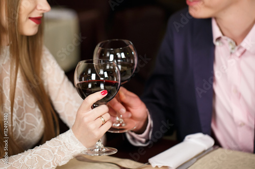 Couple toasting wineglasses in a luxury restaurant.