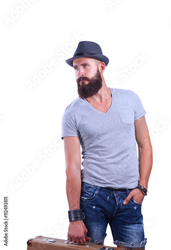 Portrait of handsome bearded man in hat standing with bad, isolated on white background
