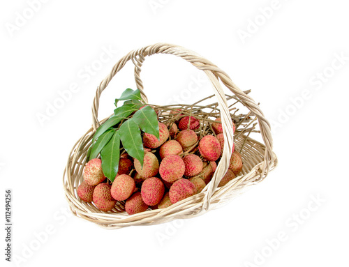 Fresh bunch of lychees fruit in rattan basket isolated on white