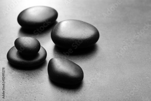Heap of spa hot stones  on grey background