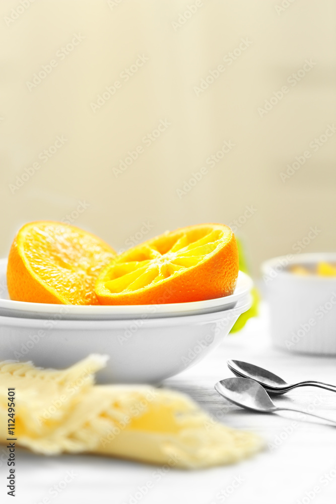 Eating oranges with spoon on white table Eating oranges with spoon on white table