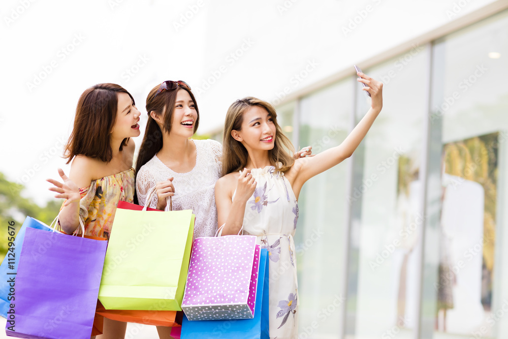 happy young Women Taking Selfie while Shopping happy young Women Taking Selfie while Shopping