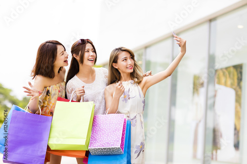 happy young Women Taking Selfie while Shopping