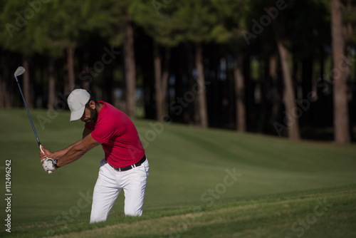 golfer hitting a sand bunker shot