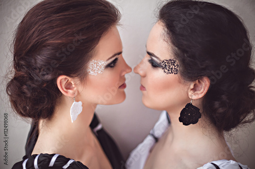 Two girls with black and white fantasy make-up photo