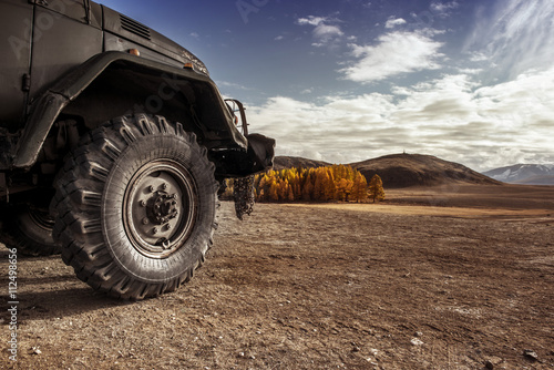 Truck car wheel on offroad steppe adventure trail photo