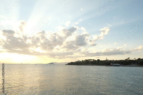 Sea Sunset in Aegina, with wievs to Kolonna ancient ruins, Greec photo
