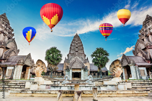 Hot-air balloons flying over blue sky at Ancient Bayon castle, Angkor Thom, Chiangrai, Thailand. photo